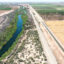 An aerial view shows the long-depleted Colorado River as it flows between California and Arizona. An irrigation ditch (right) carries the river water toward Quechan tribal land on May 26, 2023 near Winterhaven, Calif. Credit: Mario Tama/Getty Images