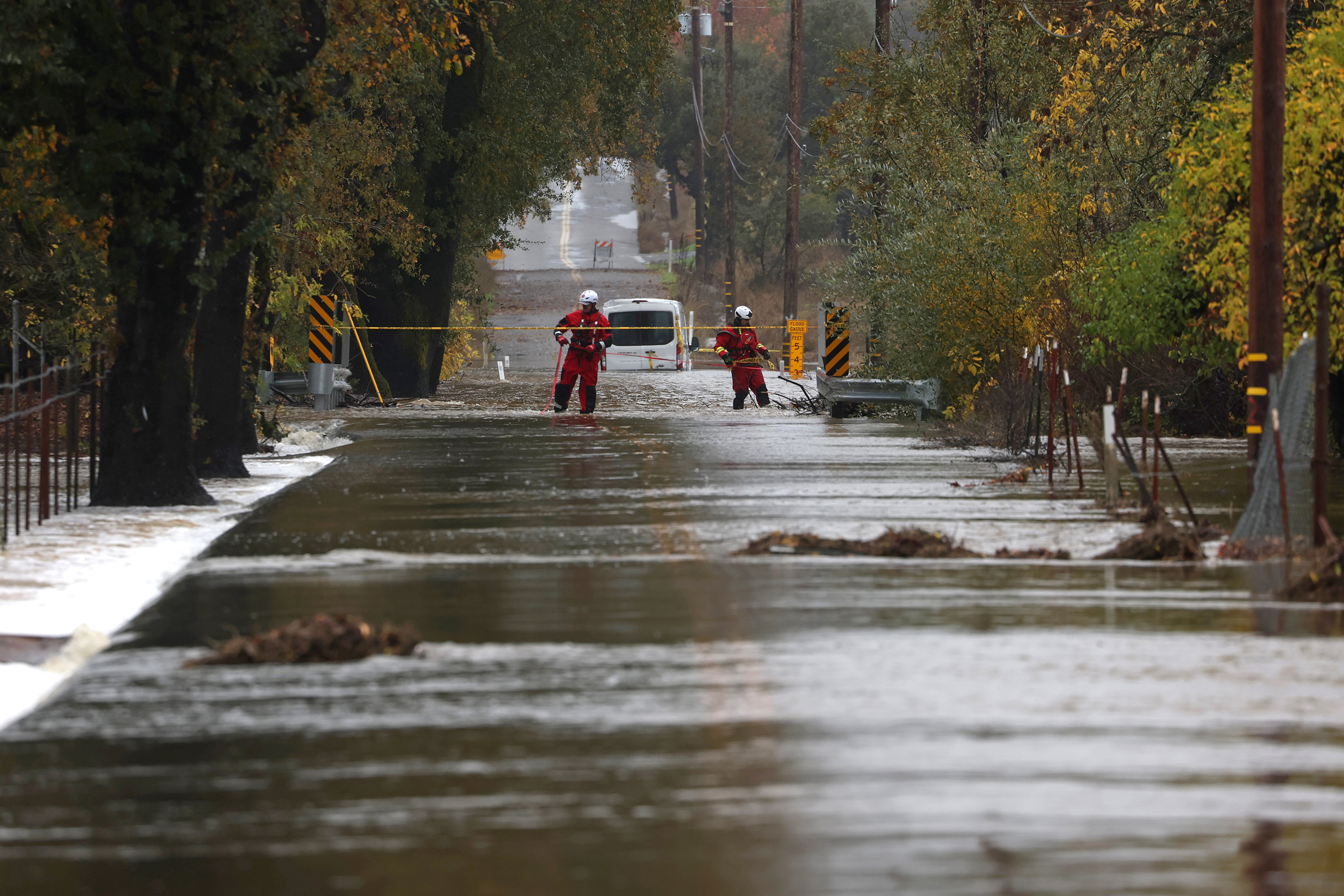 Firefighters block off a flooded road as a powerful atmospheric river brings heavy rains and wind to the San Francisco Bay Area on Nov. 22 in Windsor, Calif. Credit: Justin Sullivan/Getty Images