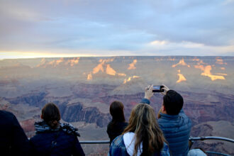 Tourists visit the South Rim of the Grand Canyon on Nov. 1, 2022. The Colorado River flows through the literal giant chasm in Arizona. Credit: Alex Hager/KUNC