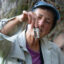 Kerry Schwartz, a retired hydrogeology faculty member and water resources educator at the University of Arizona, holds up a small sample of water from the spring in Alum Gulch. Credit: Esther Frances/Inside Climate News