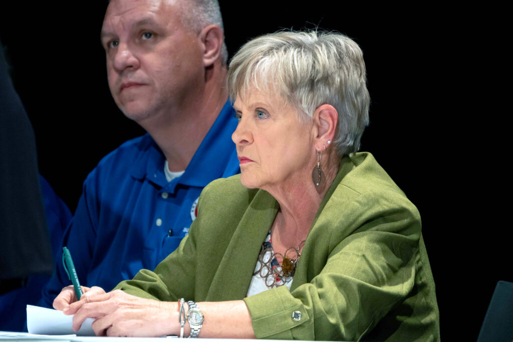 Kathy Love, director of the Alabama Surface Mining Commission, listens during a discussion highlighting the consequences of longwall coal mining at Oak Grove High School. Credit: Lee Hedgepeth/Inside Climate News