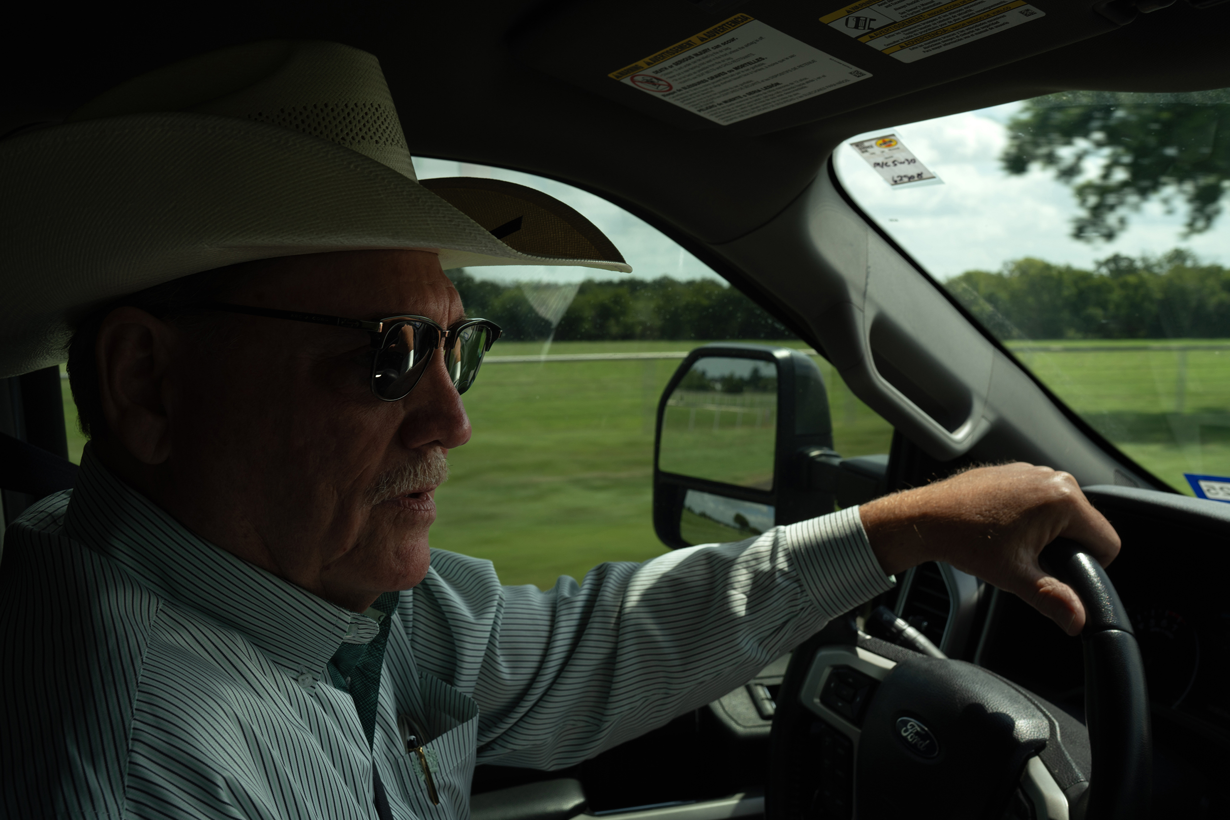 County Commissioner Larry Woolley drives past PFAS-affected land in Grandview on July 29. Credit: Azul Sordo for The Texas Tribune