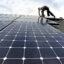 An installer with Namaste Solar secures panels for a photovoltaic solar array system on the roof of a house in Aurora, Colo. Credit: Andy Cross/The Denver Post via Getty Images