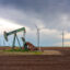 An oil pumpjack is seen near a field of wind turbines in Nolan, Texas. One of the new grants will support a clean energy reporter in Texas, making ICN’s Texas bureau its largest. Credit: Brandon Bell/Getty Images