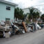 Damaged belongings are piled outside an apartment building on Oct. 5 after Hurricane Helene hit Treasure Island, Fla. Credit: Thomas Simonetti/The Washington Post via Getty Images