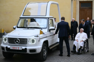 Pope Francis is presented a new, fully electric popemobile at the Vatican on Dec. 4. Credit: Filippo Monteforte/AFP via Getty Images