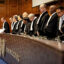 The judges of the International Court of Justice rise during a hearing to set a legal framework on how countries should tackle climate change in The Hague on Dec. 4. Credit: Robin Van Lonkhuijsen/AFP via Getty Images