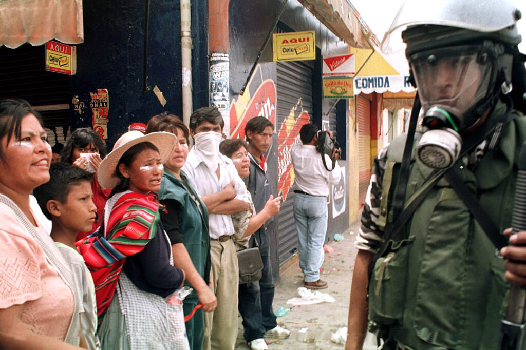 Shop vendors protest a foreign consortium’s sharp increase in water rates in Cochabamba, Bolivia, on Feb. 5, 2000. The city’s water services were privatized in the late 1990s with encouragement from the World Bank. Credit: Gonzalo Espinoza/AFP via Getty Images