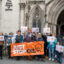 Emma Ireland and Charles Philip Laurie from Just Stop Oil pose with their supporters outside of the Royal Courts of Justice in London before their hearing on Oct. 22. Credit: Keerti Gopal/Inside Climate News