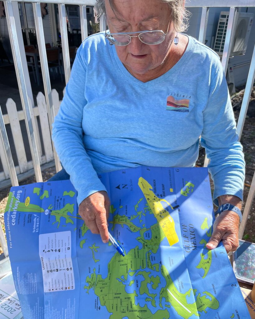 Mayor Sue Colson holds a map of Cedar Key. Credit: Amy Green/Inside Climate News