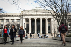 People walk though MIT’s campus in the Kendall Square neighborhood of Cambridge, Mass. Credit: Erin Clark/The Boston Globe via Getty Images