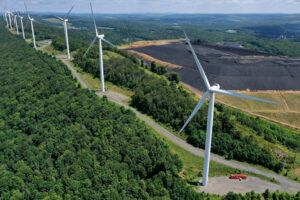 An aerial view of wind turbines on the spine of Backbone Mountain next to a coal processing plant in Oakland, Md. Credit: Chip Somodevilla/Getty Images