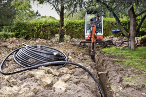 Pipes for a geothermal heating system are dug into the ground using an excavator. Credit: MyLoupe/Universal Images Group via Getty Images