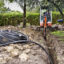 Pipes for a geothermal heating system are dug into the ground using an excavator. Credit: MyLoupe/Universal Images Group via Getty Images
