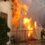 A firefighter sprays water on a house to protect it from the Eaton Fire in the Altadena neighborhood on Jan. 8, 2025 in Pasadena, Calif. Credit: Nick Ut/Getty Images
