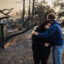 A man comforts his daughter on the charred ruins of their family home burned in the Eaton Fire on Jan. 9 in Altadena, Calif. Credit: Zoë Meyers/AFP via Getty Images