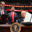 President Donald Trump holds his signed executive order announcing the U.S. withdrawal from the Paris Agreement during the inaugural parade inside Capital One Arena on Monday in Washington, D.C. Credit: Jim Watson/AFP via Getty Images
