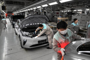 Production workers for Chinese electric vehicle manufacturer NIO do final quality control inspections at the company’s factory on Jan. 17 in Hefei, China. Credit: Kevin Frayer/Getty Images