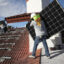 Workers install solar panels on the roof of a home in Palmetto Bay, Fla. Credit: Joe Raedle/Getty Images