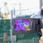 Sharon Wilson, of the non-profit Oilfield Witness, uses a gas imaging camera to capture otherwise invisible emissions from an Energy Transfer compressor station in Arlington, Texas. Credit: Dylan Baddour/Inside Climate News