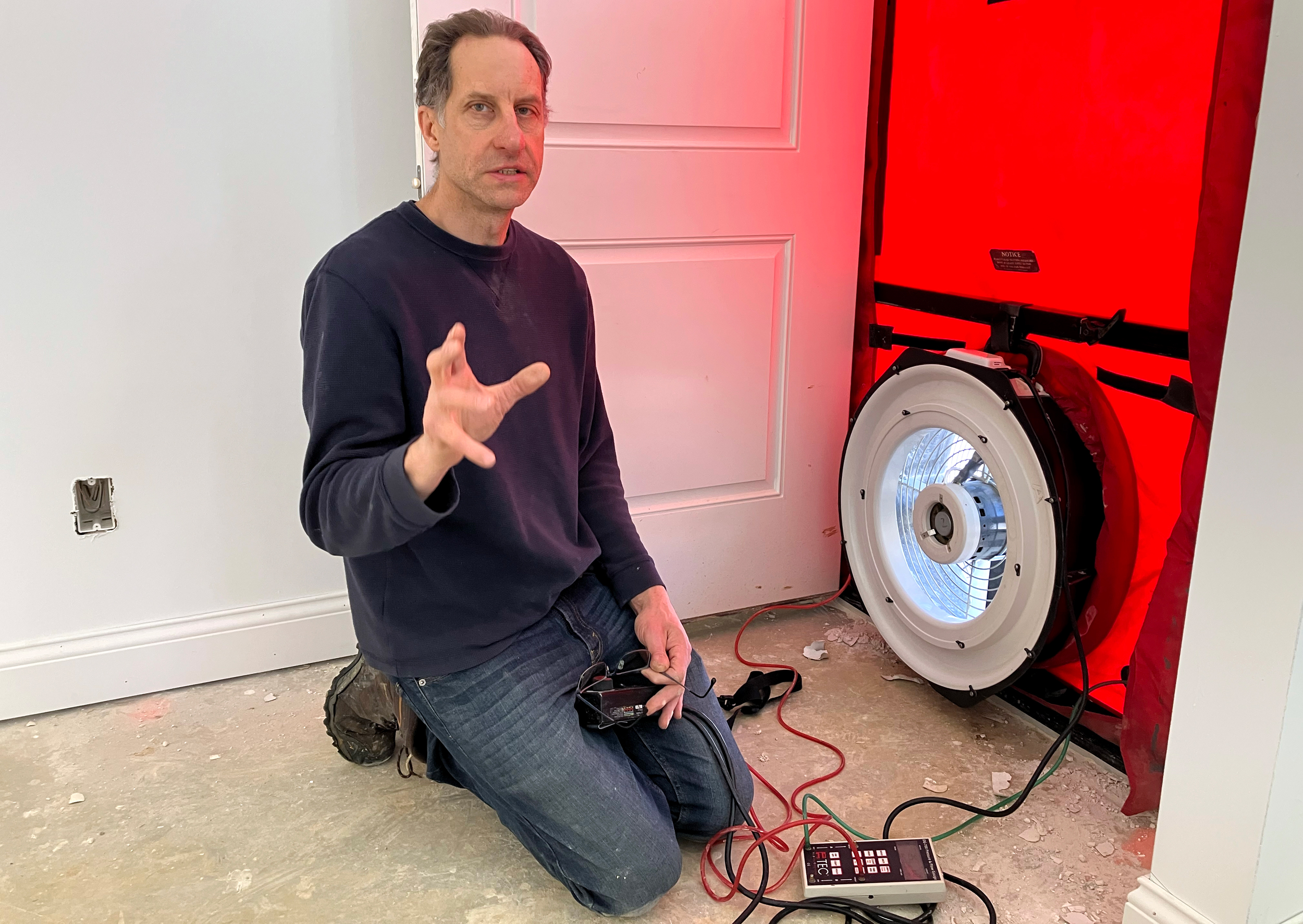 Dwayne Petko, owner and operator of Energy Matters LLC, conducts a blower door test to check for building air leaks in Sunbury, Ohio. Credit: Dan Gearino/Inside Climate News