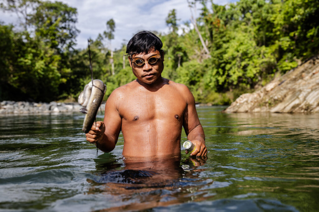 Daniel Totabo catches an eel in the river of a remote indigenous village in Halmahera on Aug. 19, 2024.