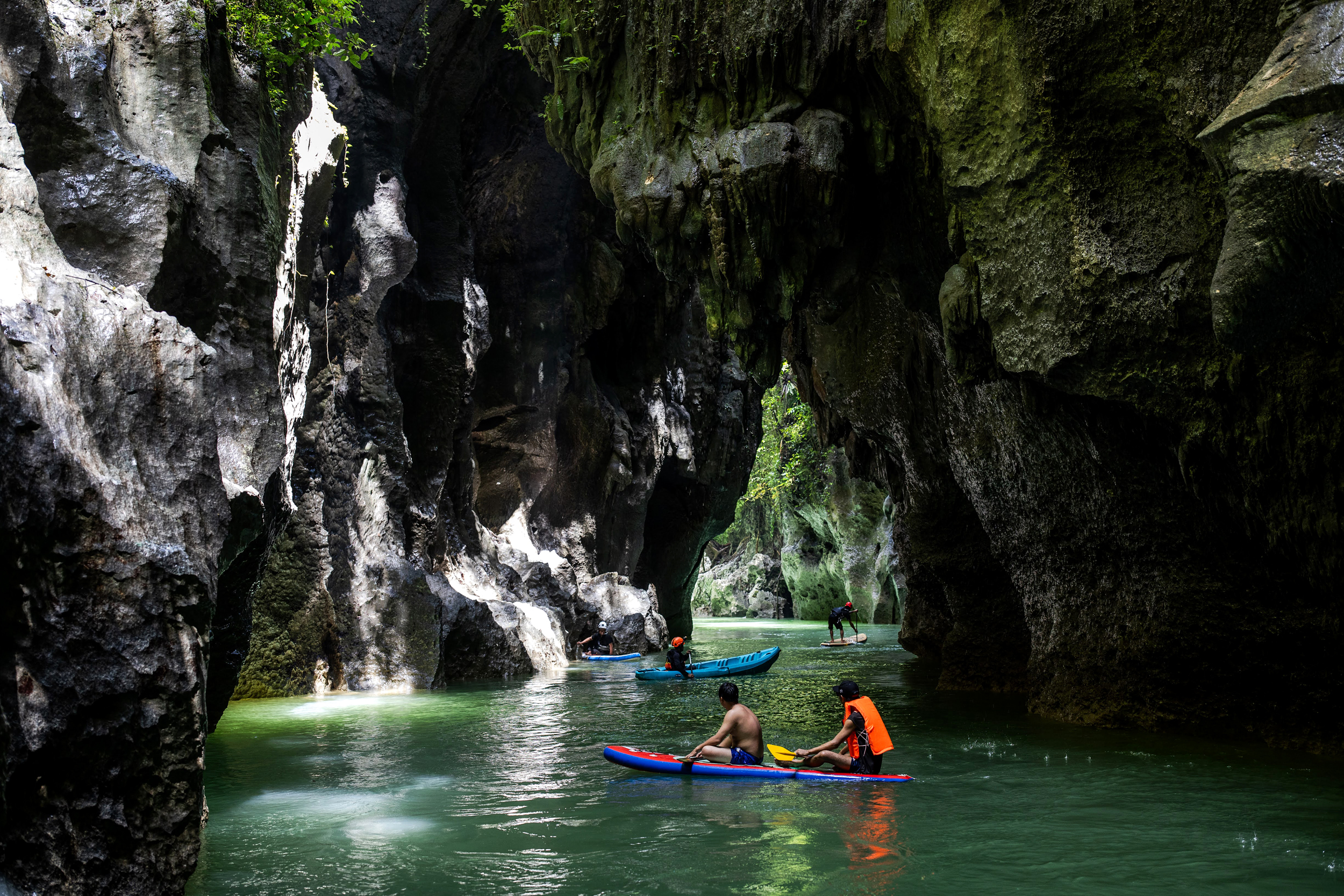 Men paddle along the underground Sagea River to check water color changes due to deforestation in the Bokimaruru karst area of the Sagea Village in Central Halmahera on Aug. 16, 2024.