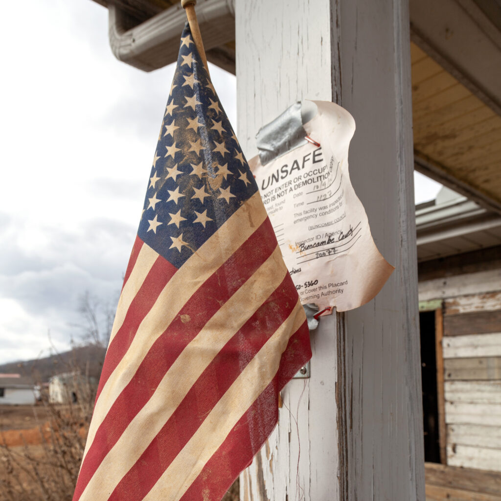 Swannanoa homes left destroyed or damaged beyond repair by Hurricane Helene display signs that say “unsafe.” Credit: Lisa Sorg/Inside Climate News