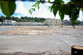 Rusted barrels and cracked concrete are all that remain of the former Glidden Paint Plant in Reading, Pa. State funding has been allocated to remediate the site prior to a planned redevelopment. Credit: Daniel Propp/Inside Climate News