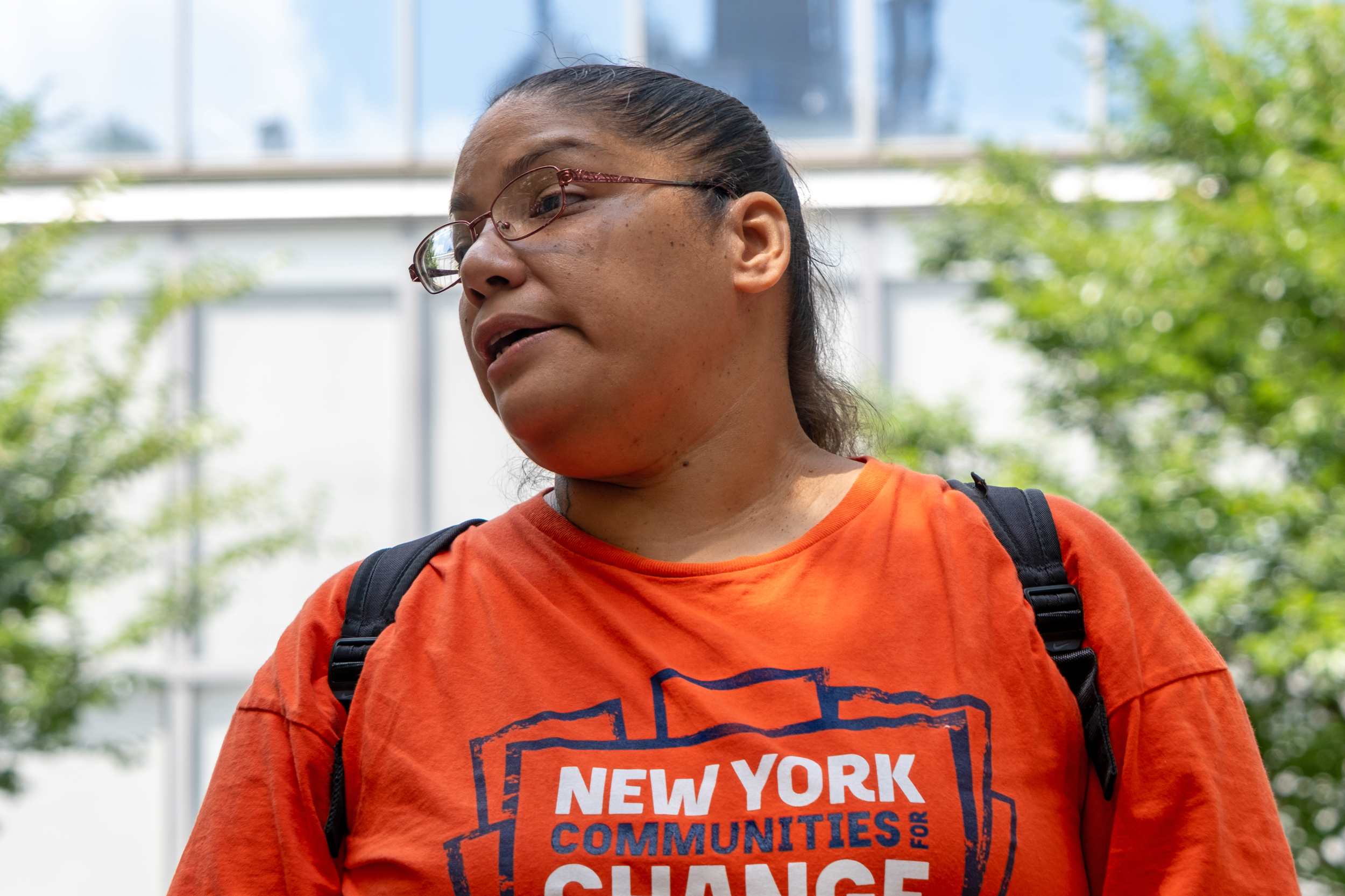 At the rally outside of Citibank’s headquarters on July 27, Rachel Rivera speaks about her daughter's severe asthma and her family's experiences with Hurricane Sandy and Hurricane Maria, drawing connections between present-day suffering and continued fossil fuel emissions. Credit: Keerti Gopal/Inside Climate News