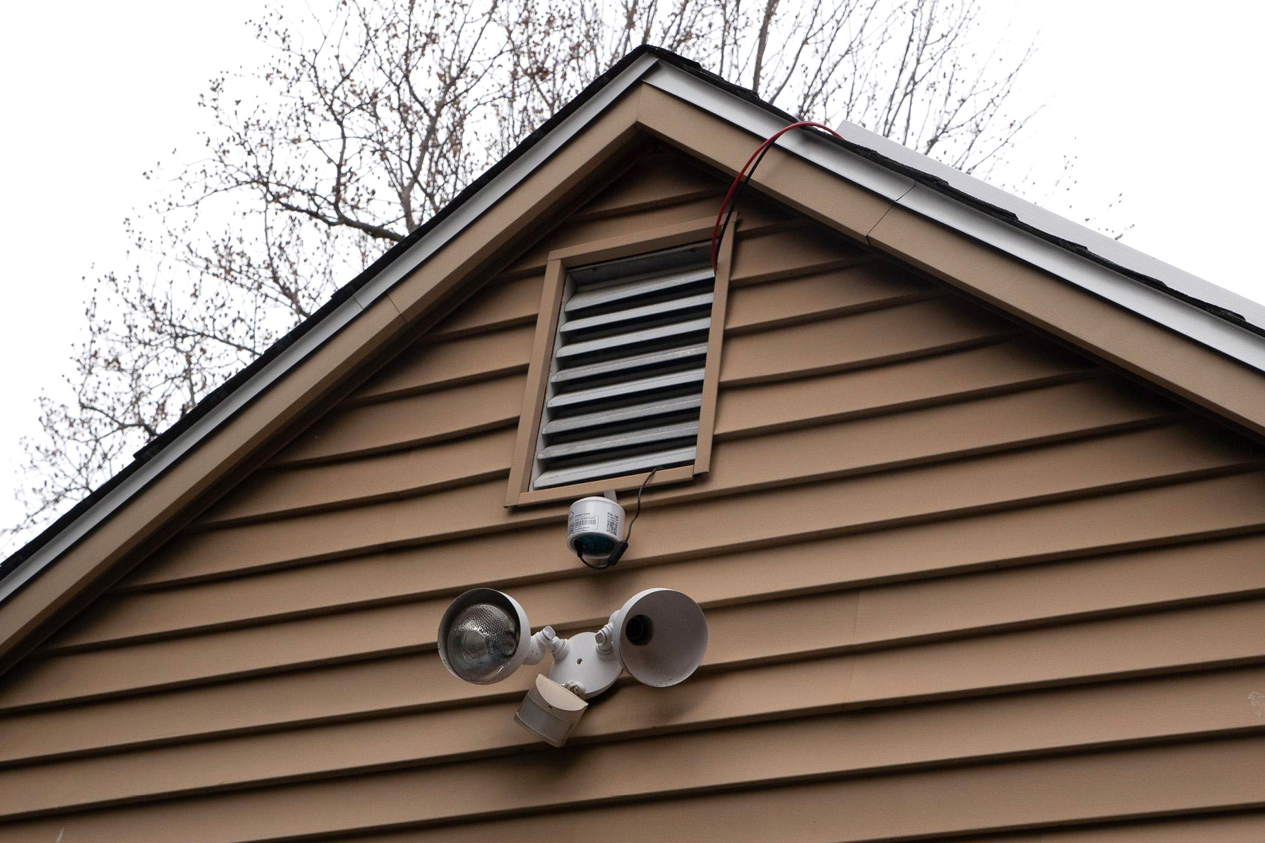 Air quality monitors like this one are usually hung high in backyards and garages to get a clear reading of the air. Credit: Rambo Talabong/Inside Climate News