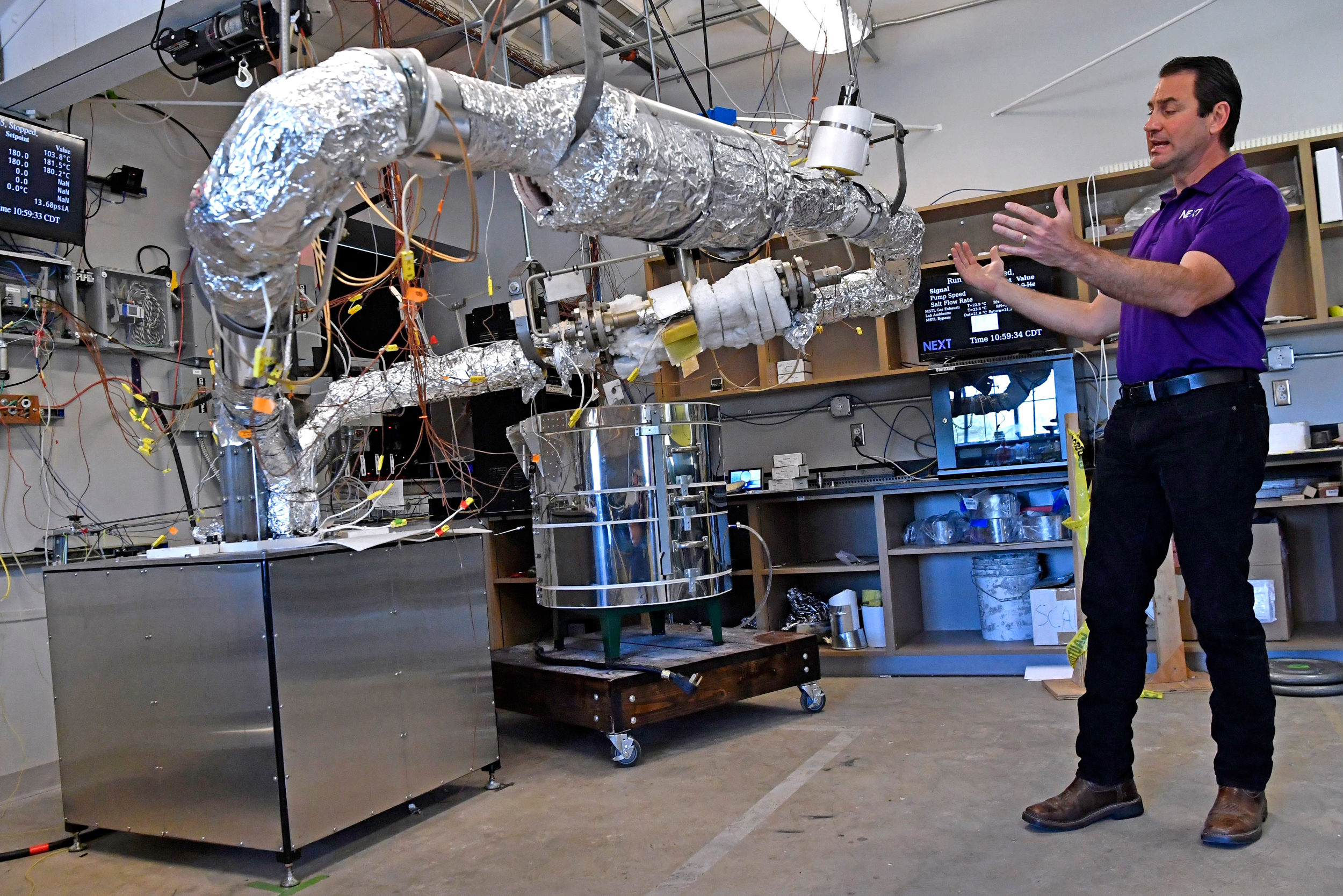 Rusty Towell, the founding director of Abilene Christian University's Nuclear Energy Experimental Testing, describes the workings of a molten salt testing device installed in the NEXT lab at Abilene Christian University. Credit: Ronald W. Erdrich/Abilene Reporter-News