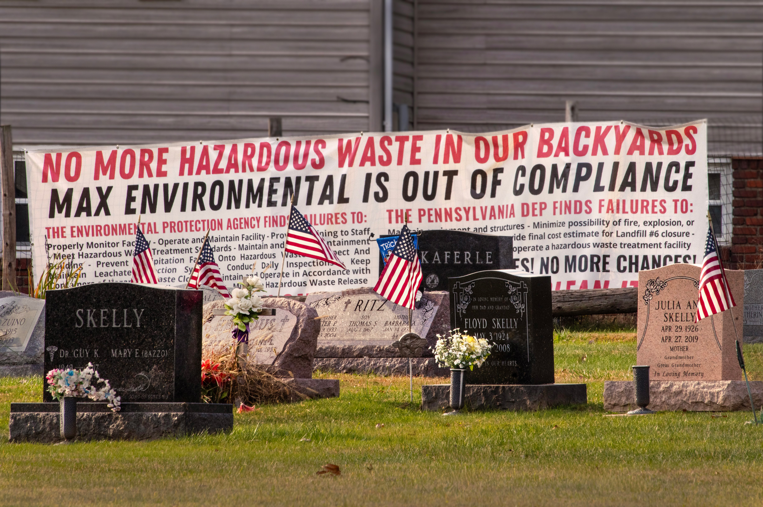 A sign opposing Max Environmental is displayed in a Catholic cemetery next to the landfill. Credit: Scott Goldsmith/Inside Climate News