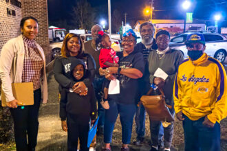 Members of the Chestnut community pose for a photo after attending a Beatrice town council meeting in early February. Credit: Lee Hedgepeth/Inside Climate News