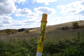 A sign indicates the presence of a pipeline below the ground in Daisytown, Penn. Credit: Nicholas Kamm/AFP via Getty Images