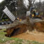 A Pennsylvania Department of the Environment crew fills in a sinkhole above an abandoned mine in Washington Township. Federal funding for remediating old mines has been frozen by the Trump administration, the state said in a lawsuit. Credit: Ben Hasty/MediaNews Group/Reading Eagle via Getty Images