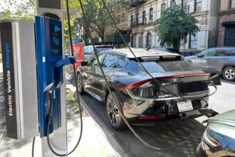 Electric vehicles connect to an EV charging station in New York City. Credit: Plexi Images/Universal Images Group via Getty Images