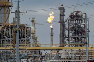 Gas is burned from a flare stack at the Air Liquide gas plant in Pasadena, Texas. Credit: Kirk Sides/Houston Chronicle via Getty Images