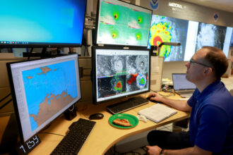 A worker at NOAA’s National Hurricane Center tracks Hurricane Beryl in Miami on July 1, 2024. Credit: Joe Raedle/Getty Images
