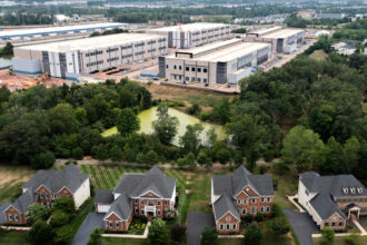 An aerial view of Amazon Web Services data center situated near a neighborhood in Stone Ridge, Va. Northern Virginia is home to the world’s largest concentration of data centers. Credit: Nathan Howard/Getty Images