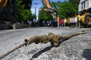 A section of lead pipe that supplied drinking water to a home in Troy, N.Y. is removed on May 20, 2024. Credit: Will Waldron/Albany Times Union via Getty Images