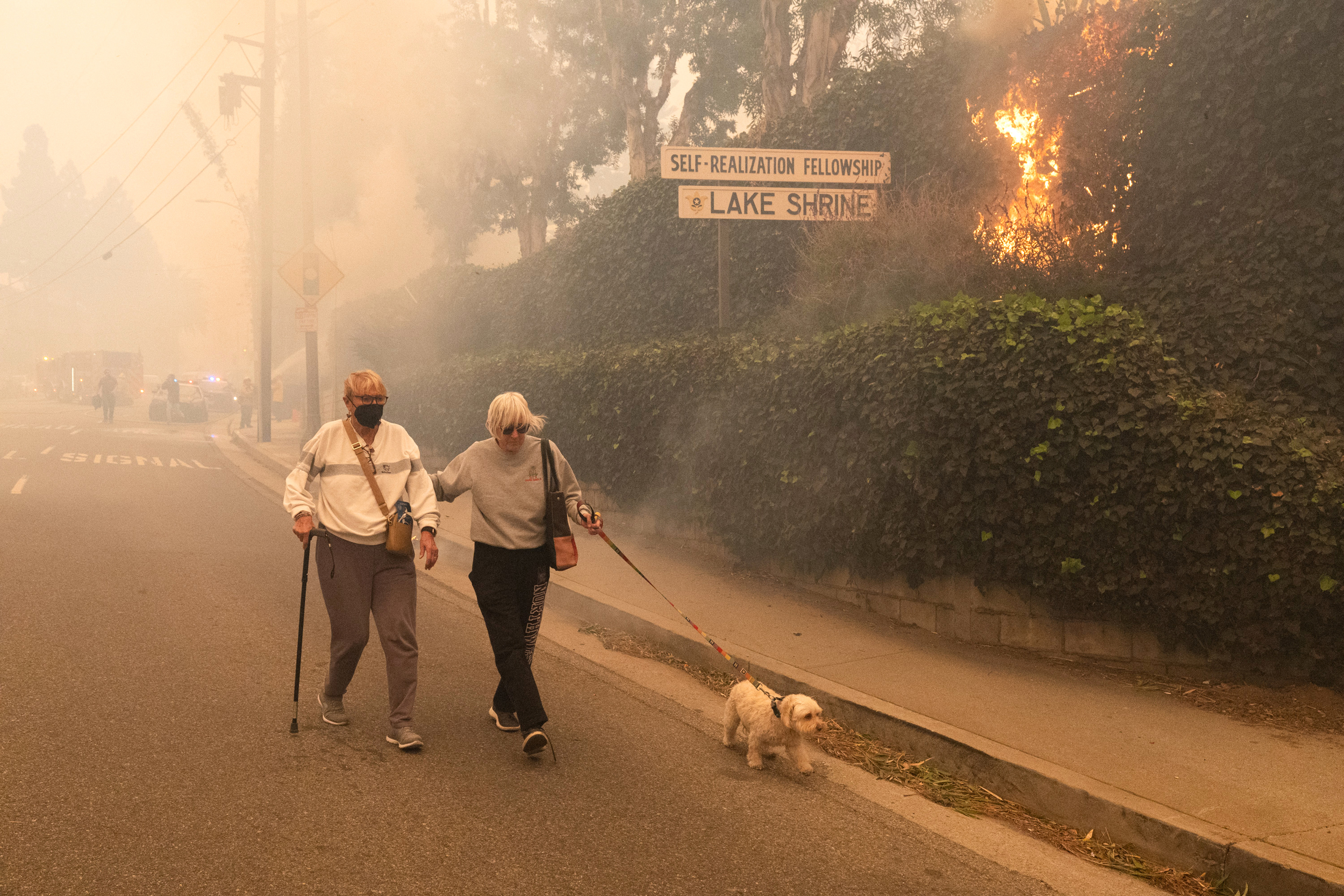Residents evacuate their home as a brush fire burns on Jan. 7 in the Pacific Palisades neighborhood of Los Angeles. Credit: Qian Weizhong/VCG via Getty Images