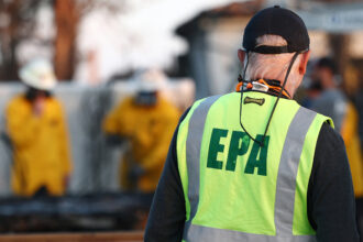 An EPA representative works in a residential area which burned during the Palisades Fire on Jan. 28 in Los Angeles. Credit: Mario Tama/Getty Images