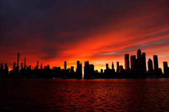 A beautiful golden-red sky is the backdrop against a silhouetted skyline