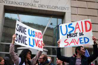Protestors gather outside of USAID headquarters on Monday in Washington, D.C. Credit: Kayla Bartkowski/Getty Images