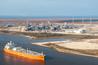 A cargo ship passes the Cheniere Energy liquefied natural gas plant on Feb. 10 in Port Arthur, Texas. Credit: Brandon Bell/Getty Images