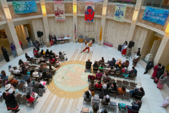 Audience members watch a ballet performance during Indigenous Women’s Day on February 8 in the rotunda of the New Mexico State Capitol in Santa Fe. Credit: Noel Lyn Smith/Inside Climate News
