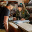 Ranger Emily Gamboa helps a visitor at the information desk at Zion National Park in Utah. Credit: NPS/Abi Farish