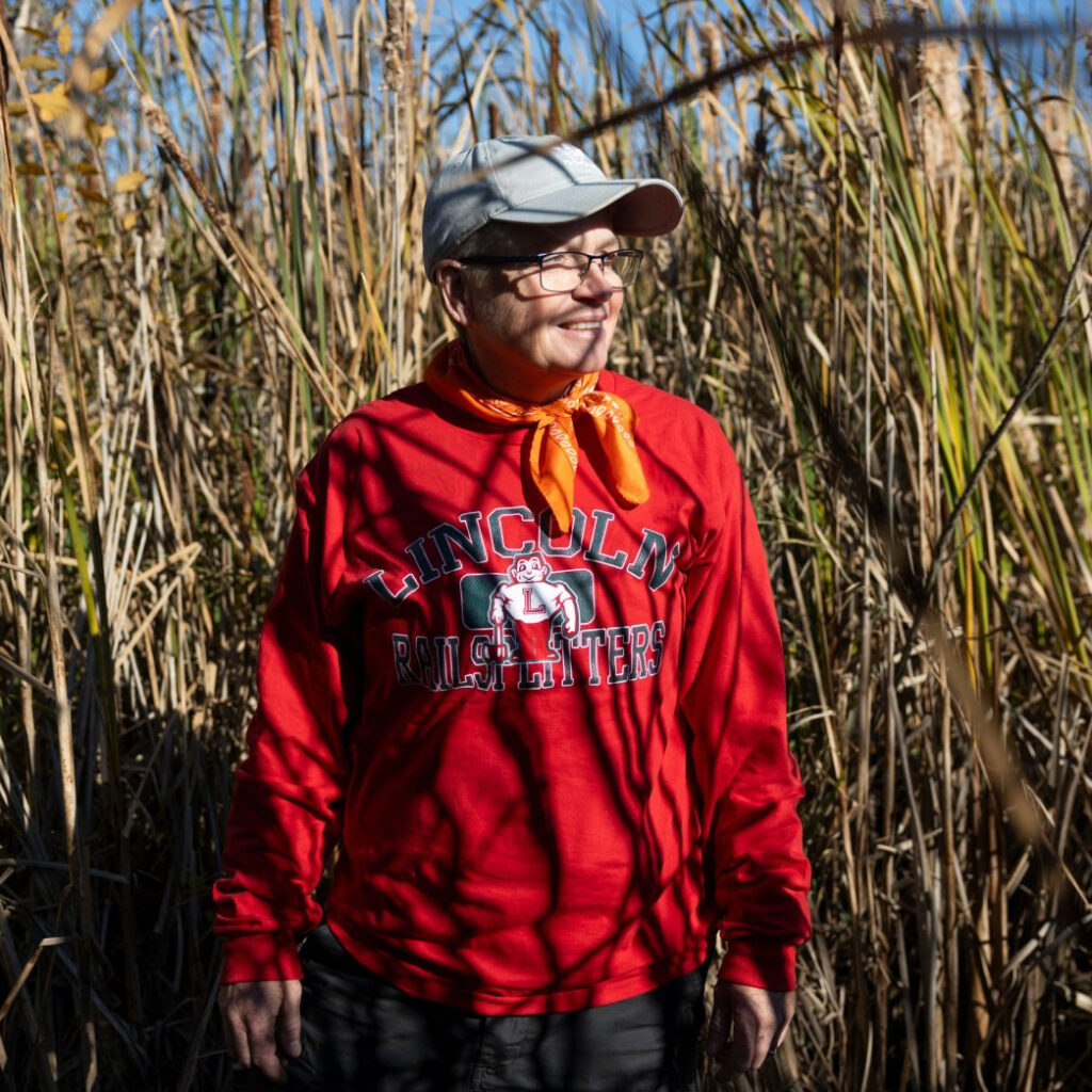 Katie McCullough is shown alongside the pond on her property on Oct. 18, 2024, near Rio, Wis. Credit: Joe Timmerman/Wisconsin Watch