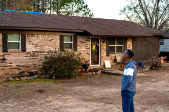 Pastor Timothy William stands outside his Shiloh home in Alabama. Credit: Lee Hedgepeth/Inside Climate News